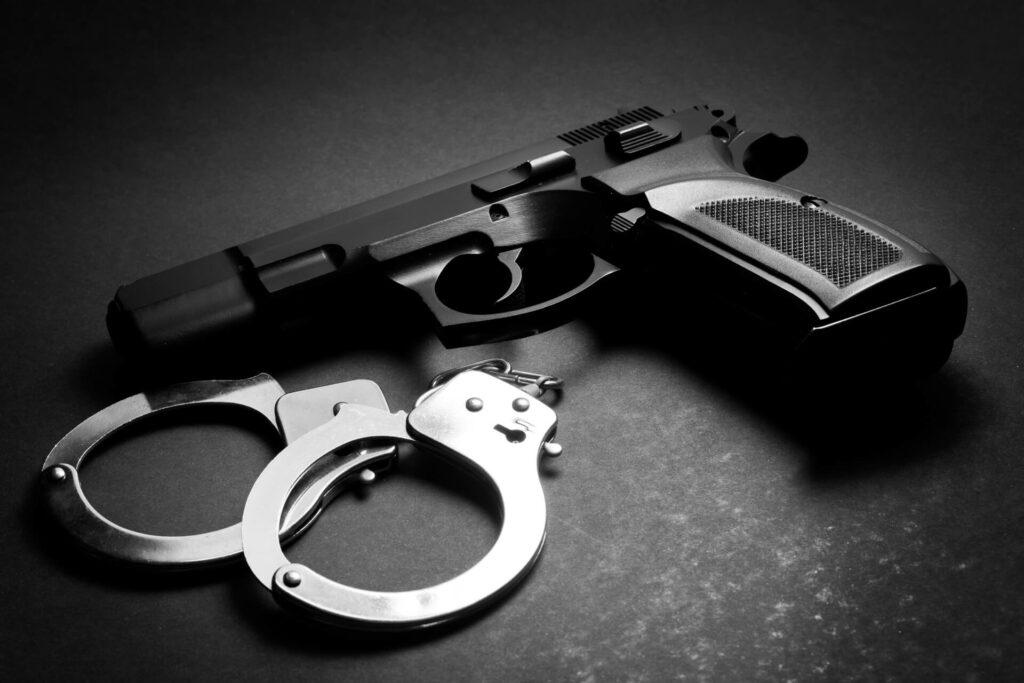 police hand gun and hand cuffs